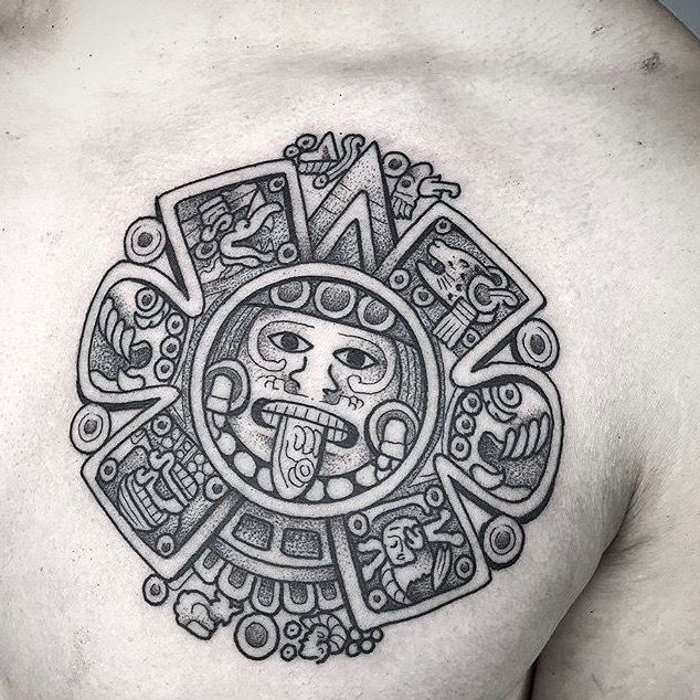 a man's chest with a tattoo design on it