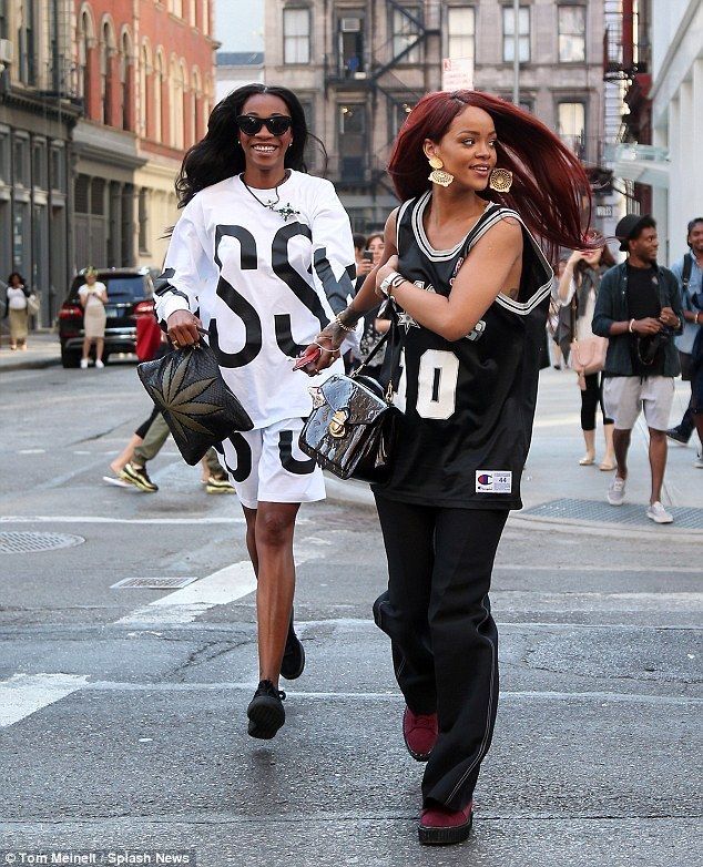 two women are walking down the street together