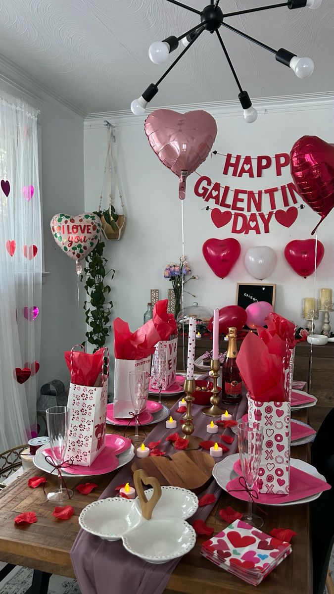 valentine's day table setting with balloons, candles and heart - shaped decorations on the wall