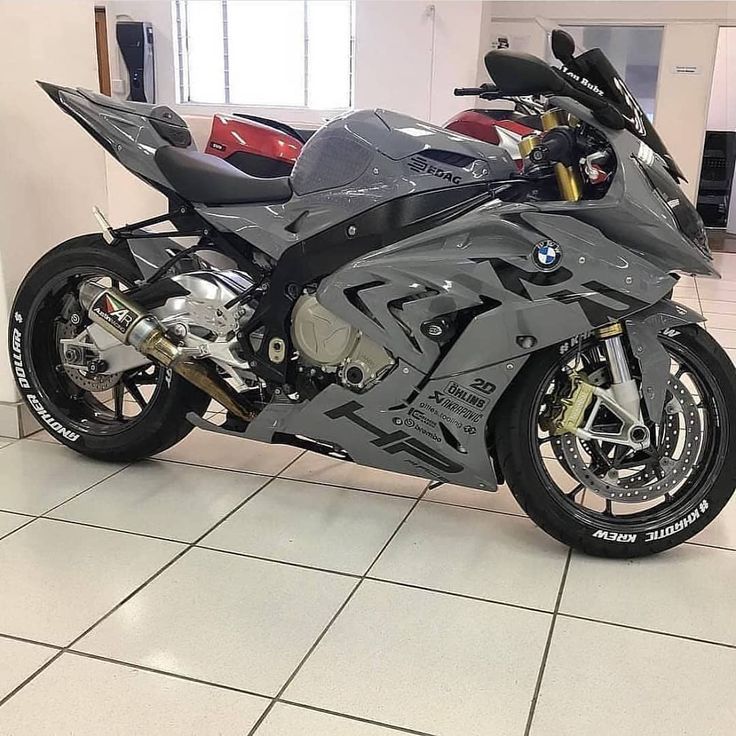 a motorcycle is parked in a building with tile flooring