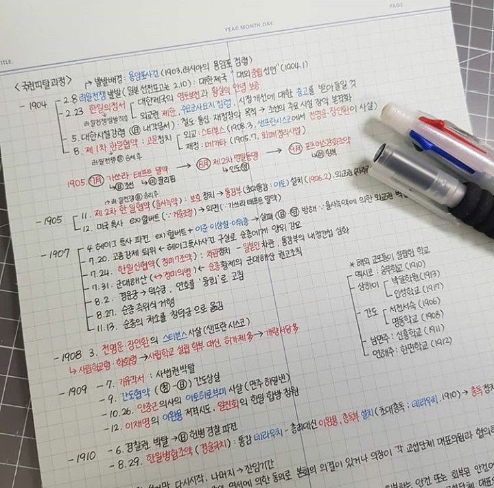 a pen sitting on top of a piece of paper with writing in korean and english