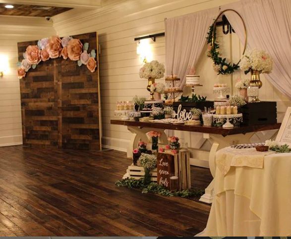 a table filled with cakes and desserts on top of a hard wood floored floor