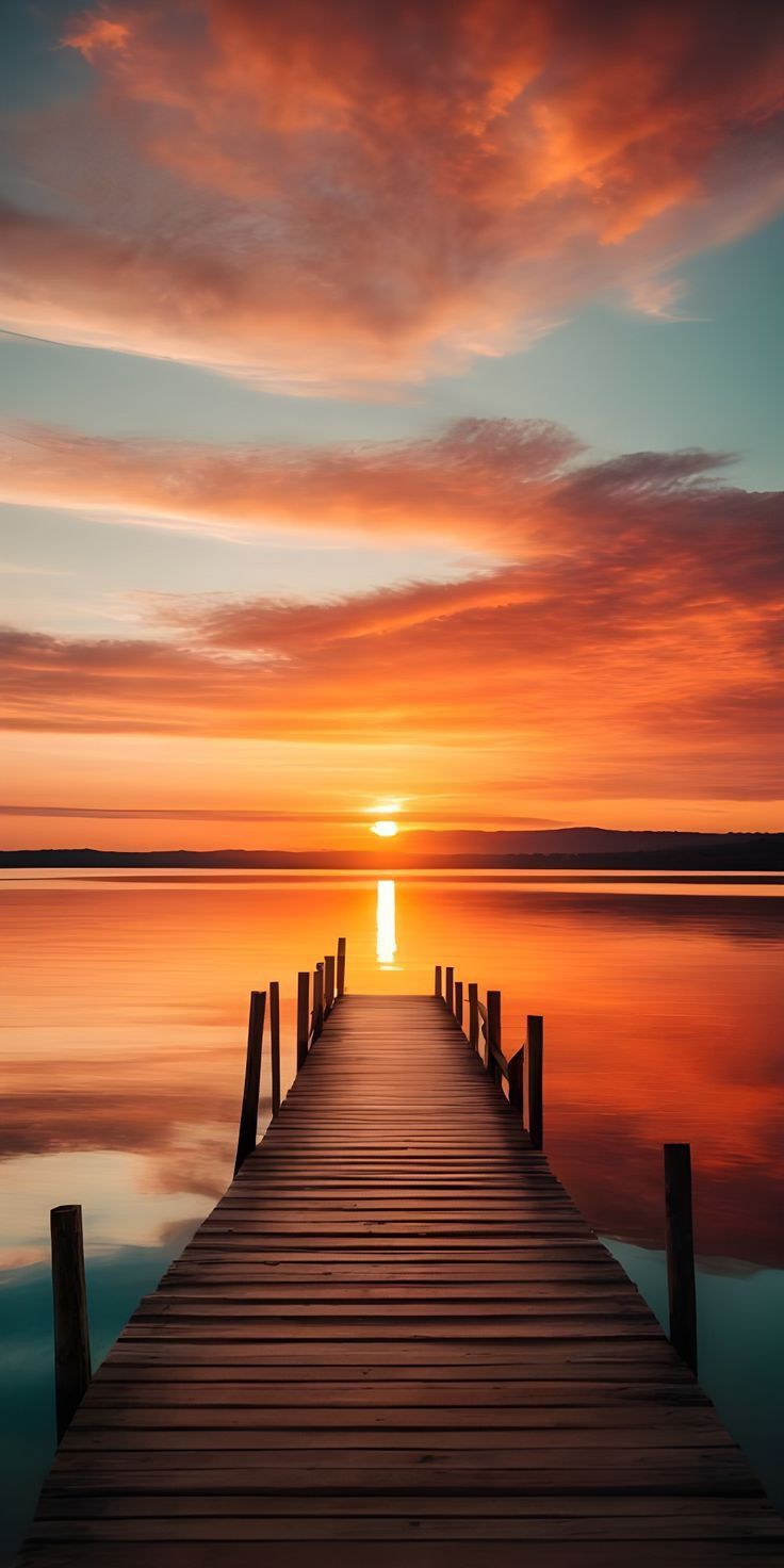 the sun is setting over water with a dock