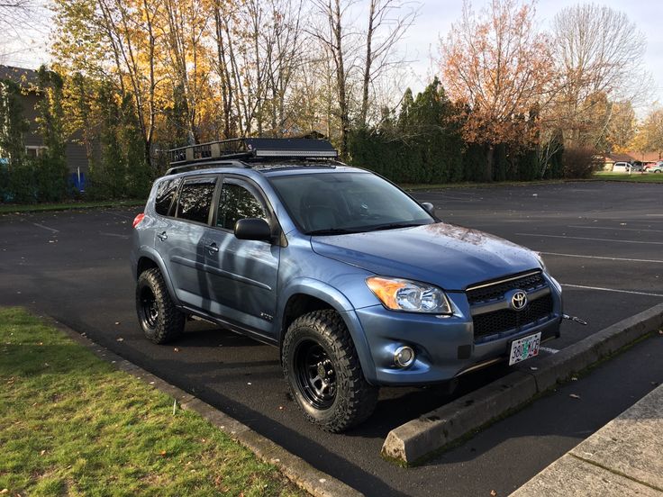 a blue suv parked in a parking lot