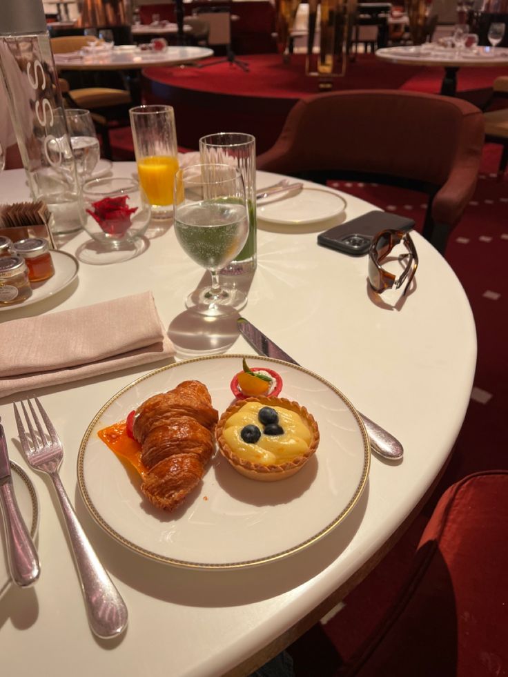 a white table topped with plates and glasses filled with food