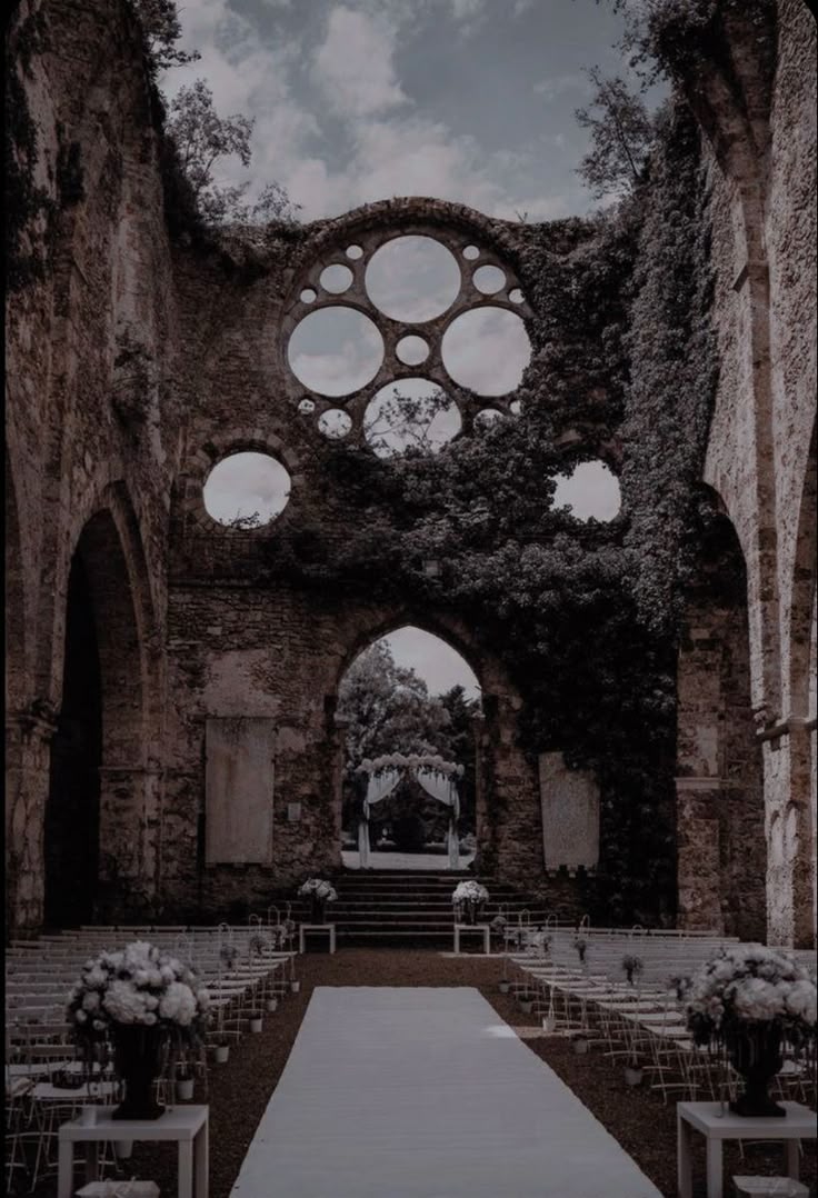 an outdoor ceremony setup with chairs and flowers on the aisle leading up to the altar