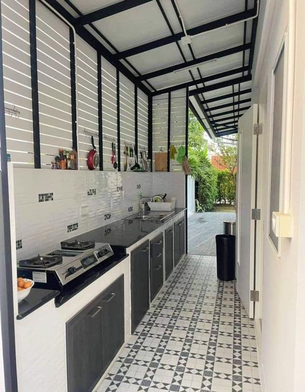 a kitchen with black and white tile flooring