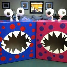 two cardboard boxes with fake teeth on them