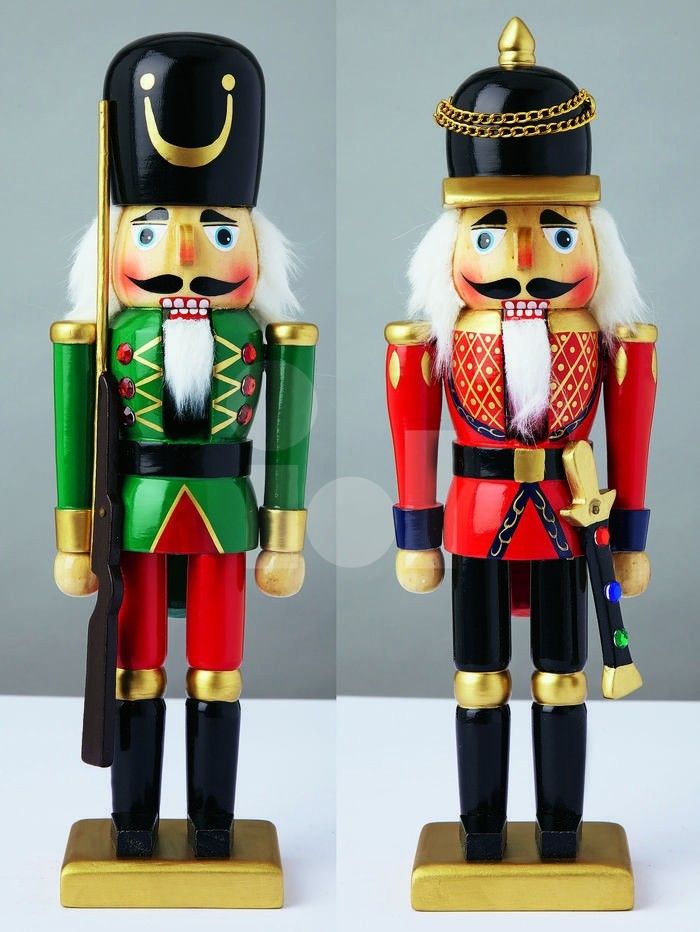 two nutcracker figurines, one in red and the other in green