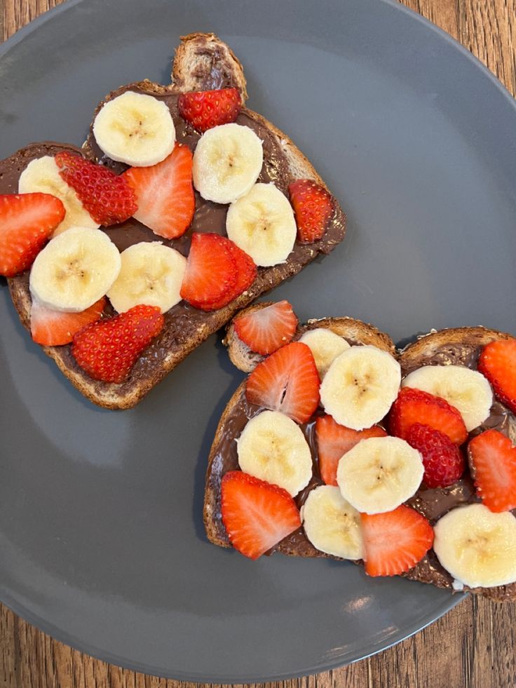 two pieces of toast with fruit on top