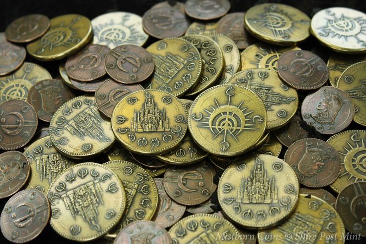 a pile of old coins sitting next to each other on top of a black table