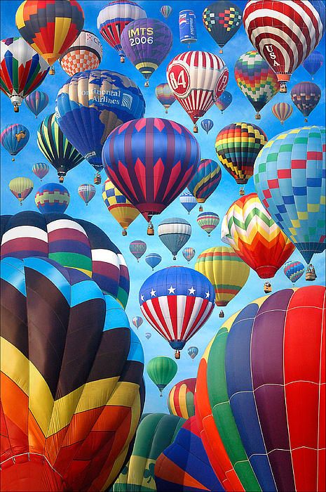 many colorful hot air balloons flying in the sky