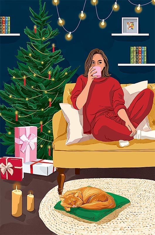 a woman sitting on a couch drinking from a cup in front of a christmas tree