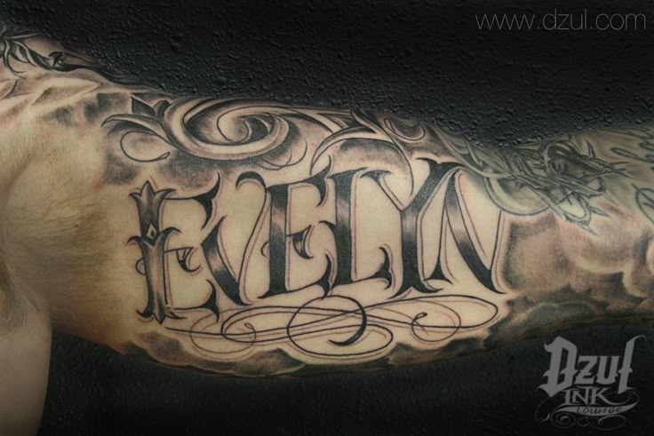 a man's arm with the word felyn tattooed on it