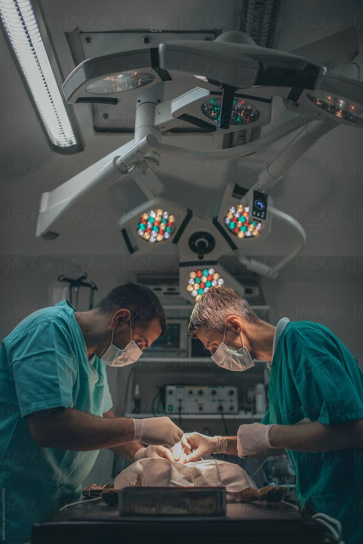 two doctors performing surgery in an operating room