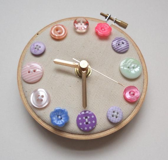 a clock made out of buttons on a white surface