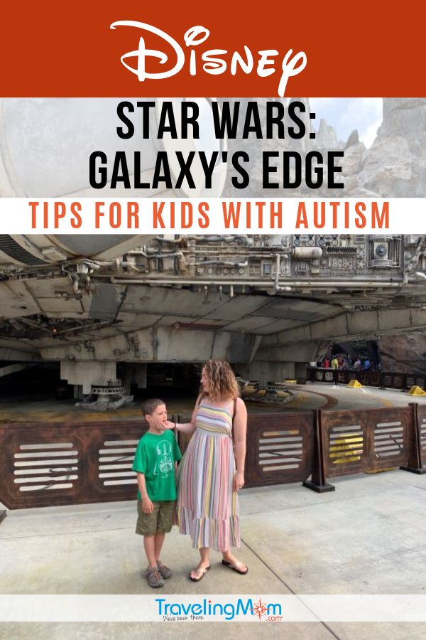 a young boy and woman standing in front of a star wars galaxy's edge