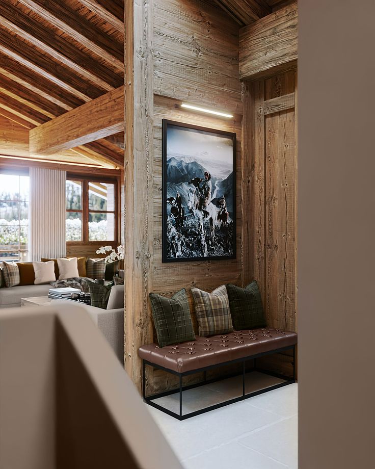 a living room filled with lots of furniture next to a painting on the wall above a couch