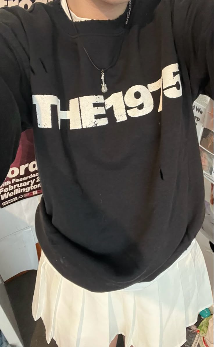 a woman wearing a black sweatshirt with the word they95 printed on it in white letters