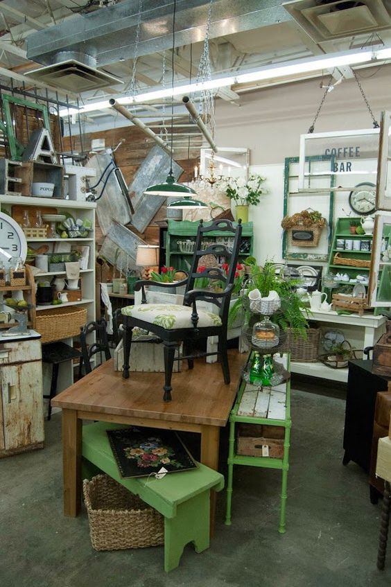 a room filled with lots of different types of furniture and decor on top of wooden tables