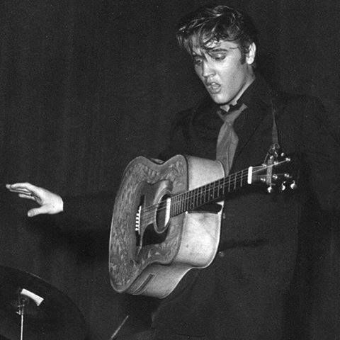 black and white photograph of man playing guitar