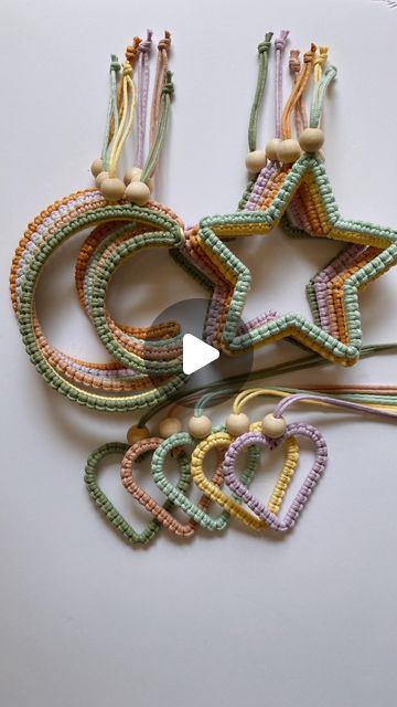 several star shaped beads and string on a white surface with a video player playing the game