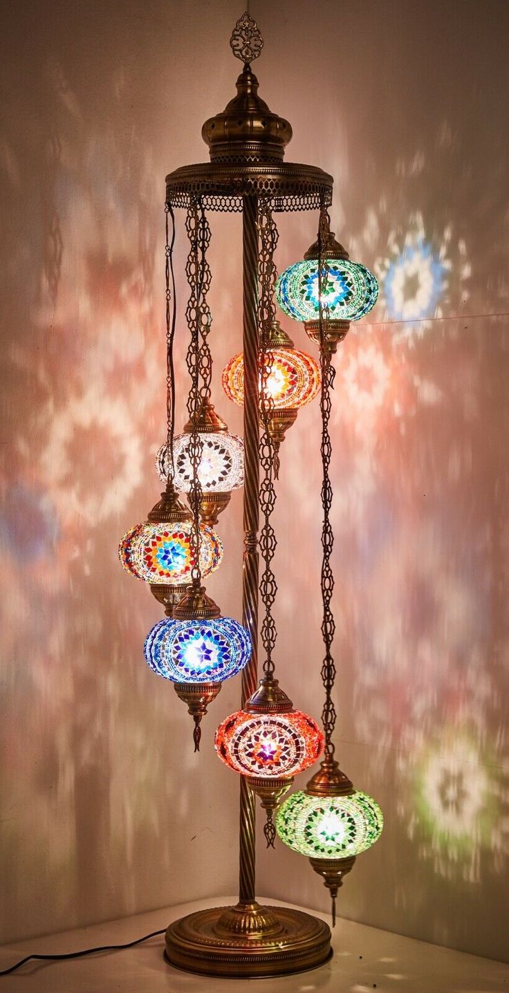 a chandelier with many different colored lights hanging from it's sides on a table