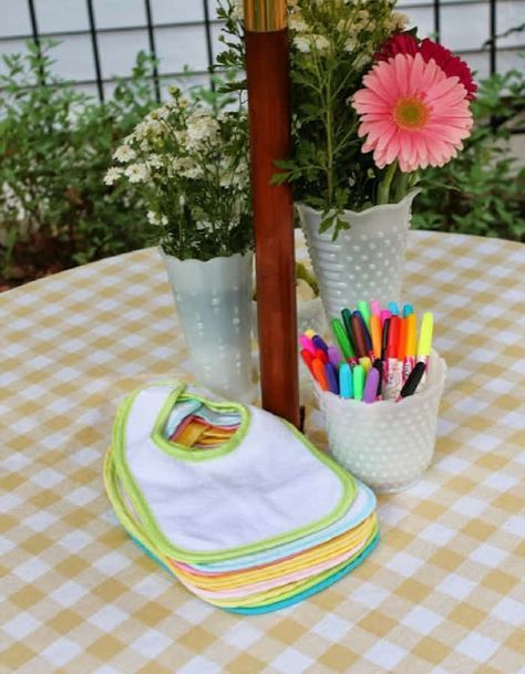 a potted plant sitting on top of a table next to a white and yellow checkered table cloth