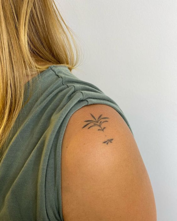 a woman with a small tattoo on her shoulder