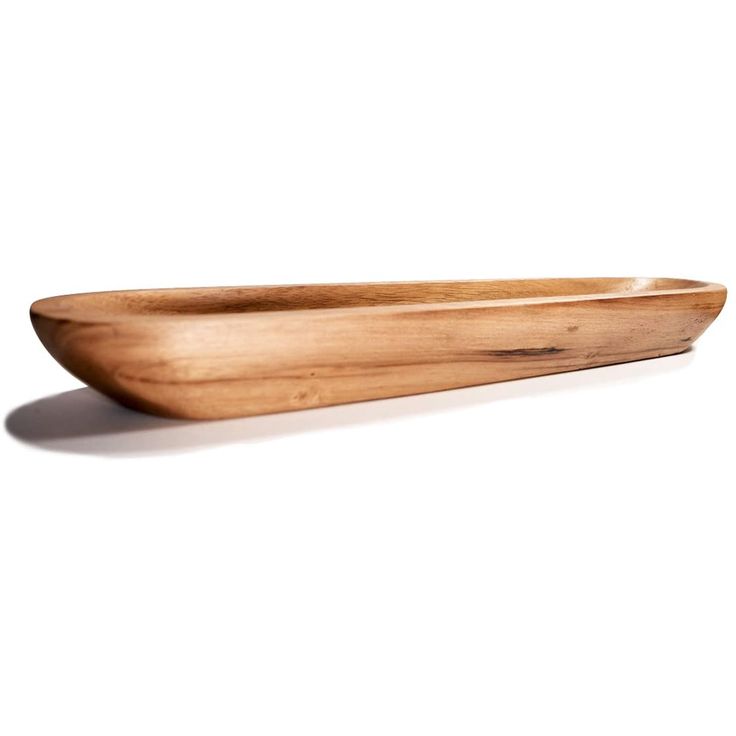 a wooden bowl sitting on top of a white surface