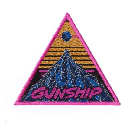 a patch with the words gunship on it and a mountain in the background,