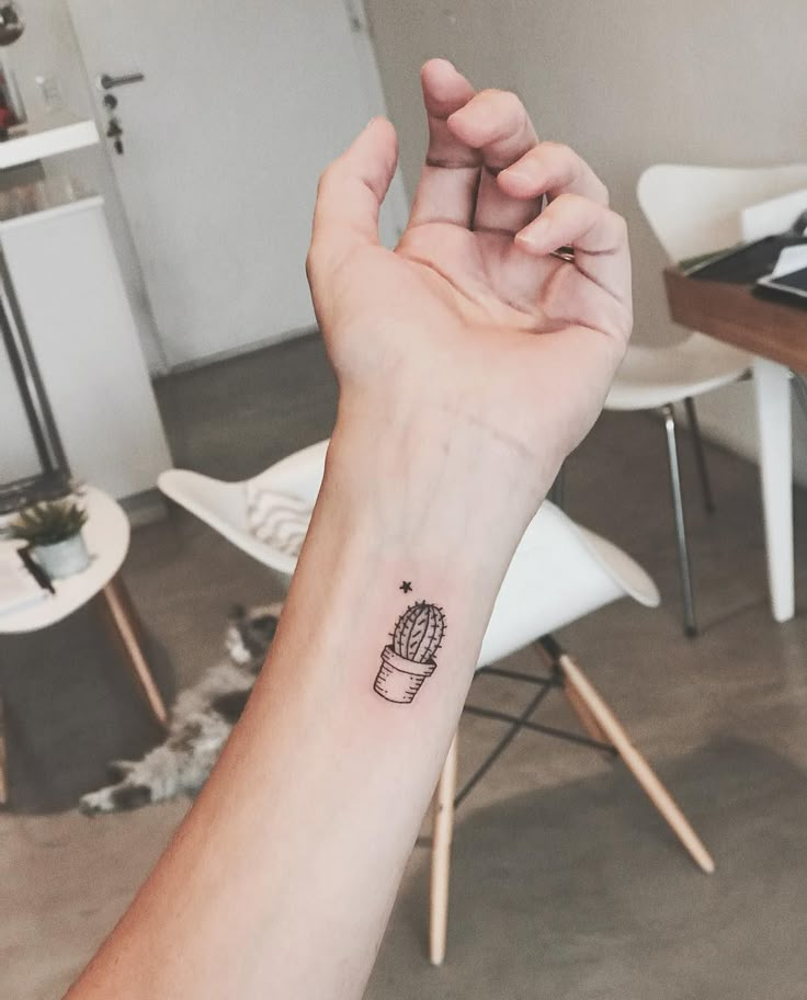 a small cactus tattoo on the wrist is shown in this image, it looks like someone has