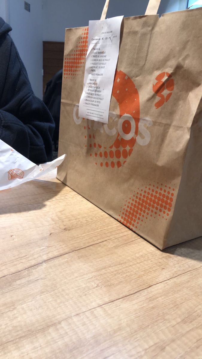 a brown paper bag sitting on top of a wooden table