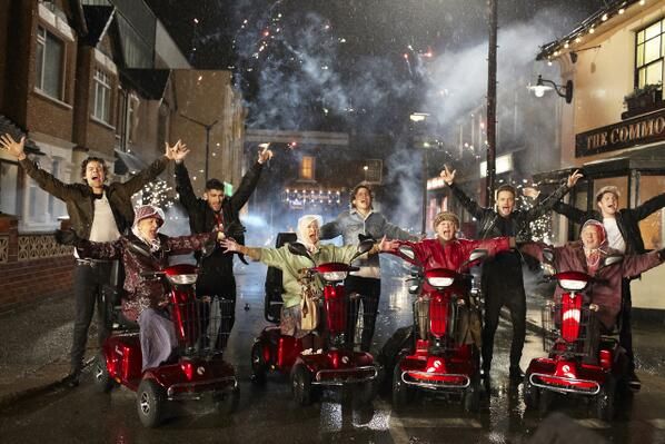 a group of people riding scooters with fireworks in the background