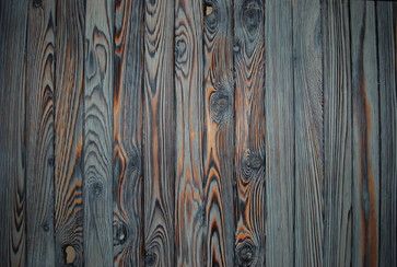 an old wood paneled wall with knots in the middle and brown paint on it