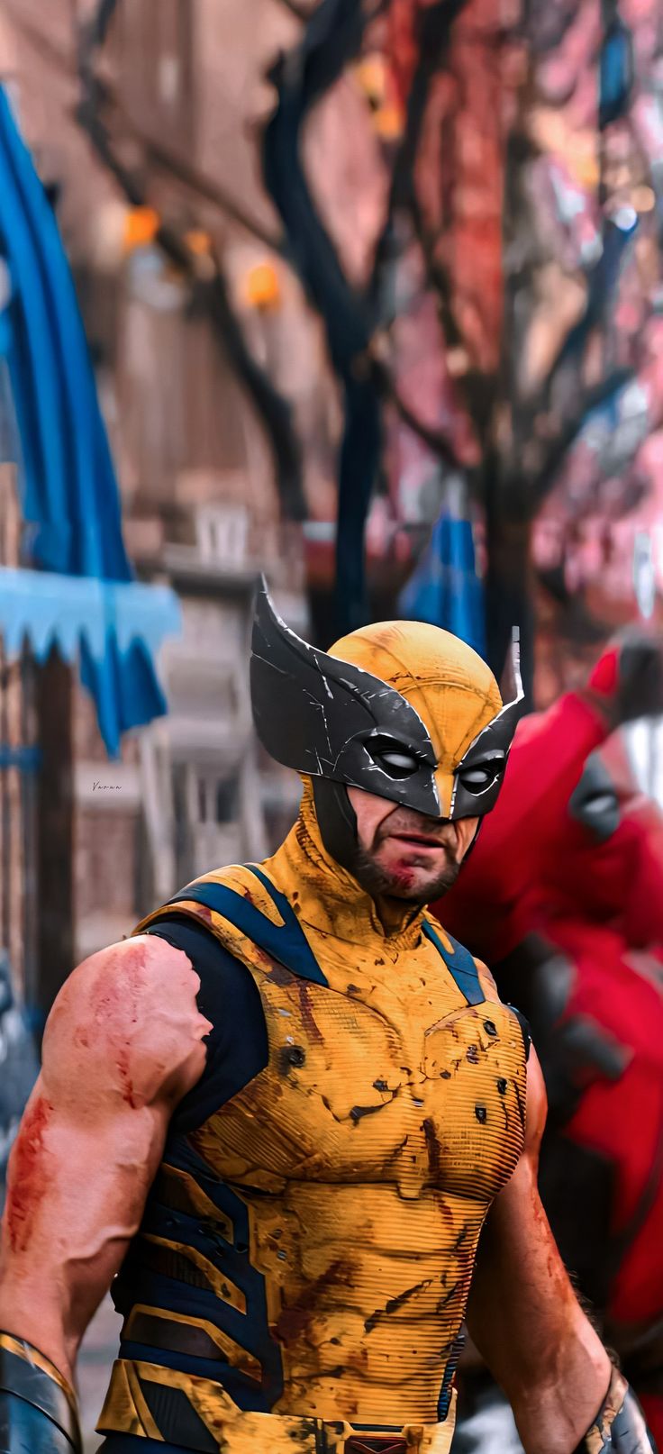 a man dressed as wolverine stands in the street