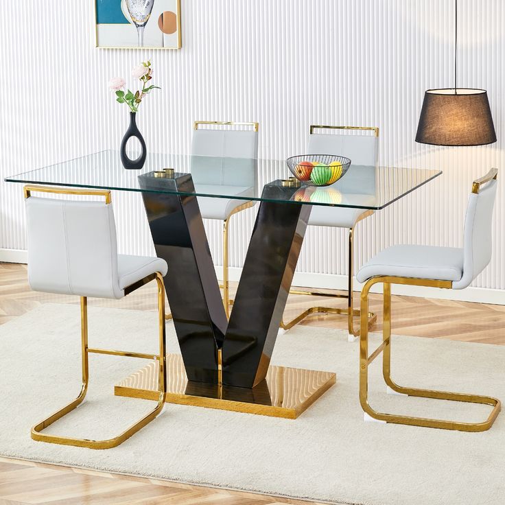 a glass dining table with white chairs and a vase on the end in front of it