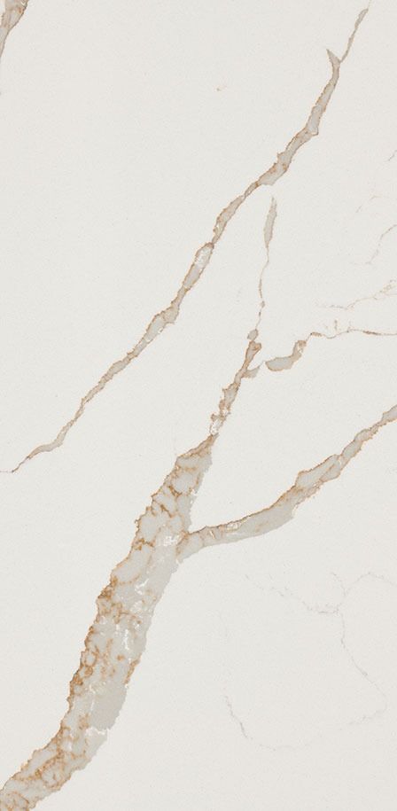 a white marble counter top with brown veining on the edges and an orange vase in the middle