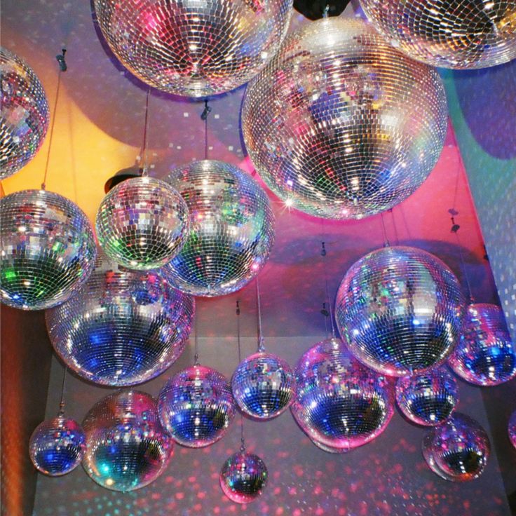 many disco balls are hanging from the ceiling