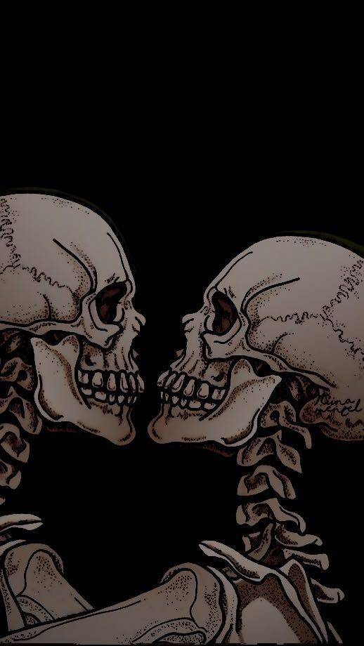 two skeleton heads touching each other with their hands in front of them, on a black background