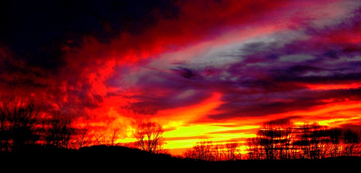 the sky is red, yellow and purple as it appears to be very colorful in this photo