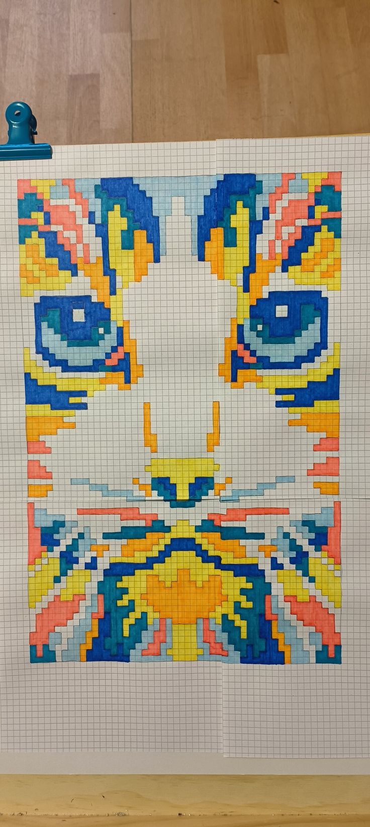 a cat made out of legos on a piece of paper