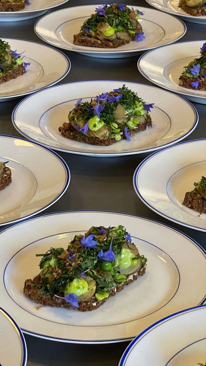 many plates with food on them are lined up in the same pattern as each other