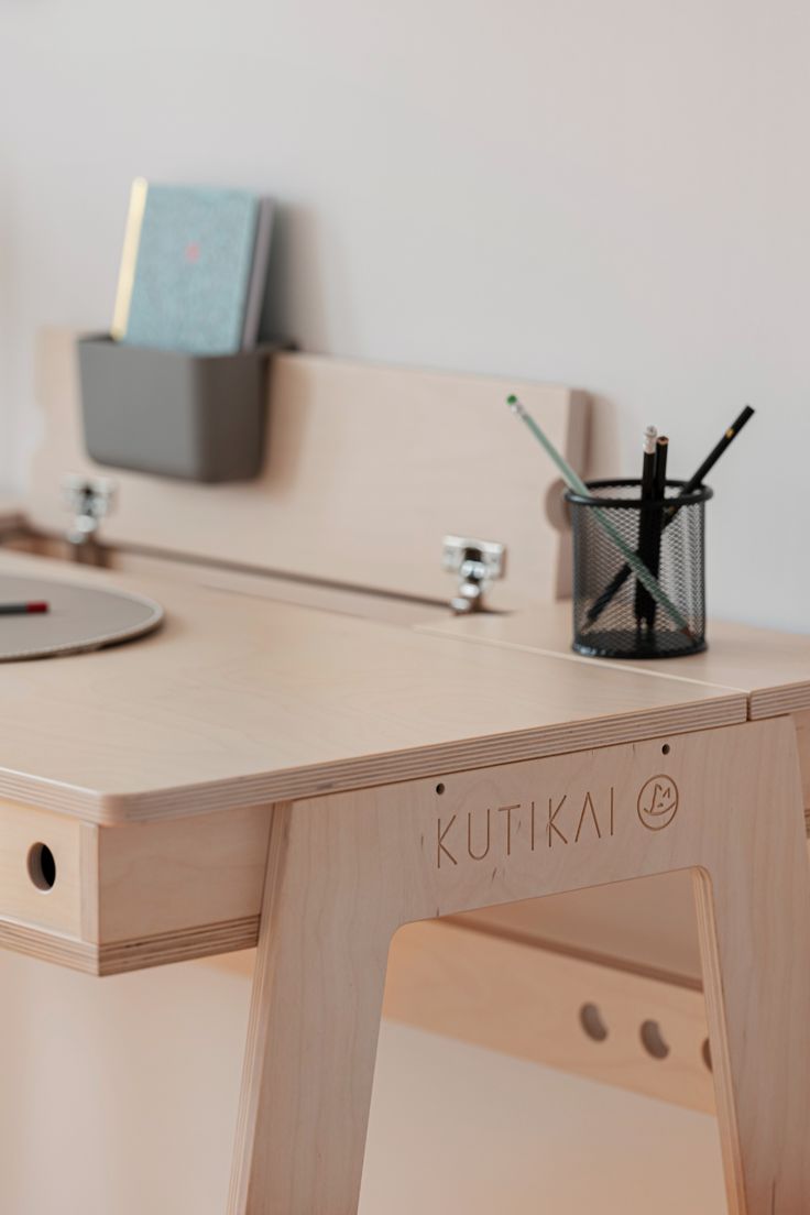 a wooden desk with an electronic device on it