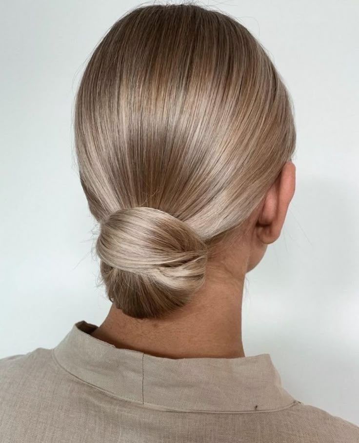 a woman with blonde hair in a low bun