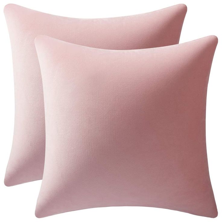 two pink pillows sitting next to each other