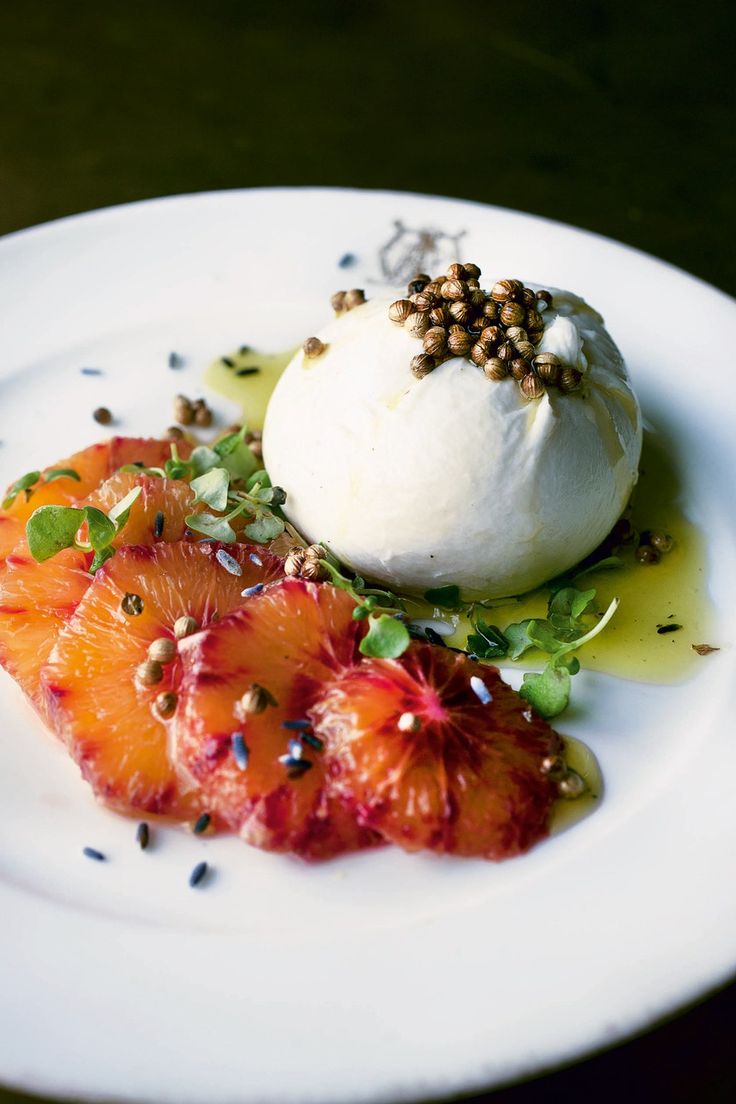 a white plate topped with food and garnishes on top of each other