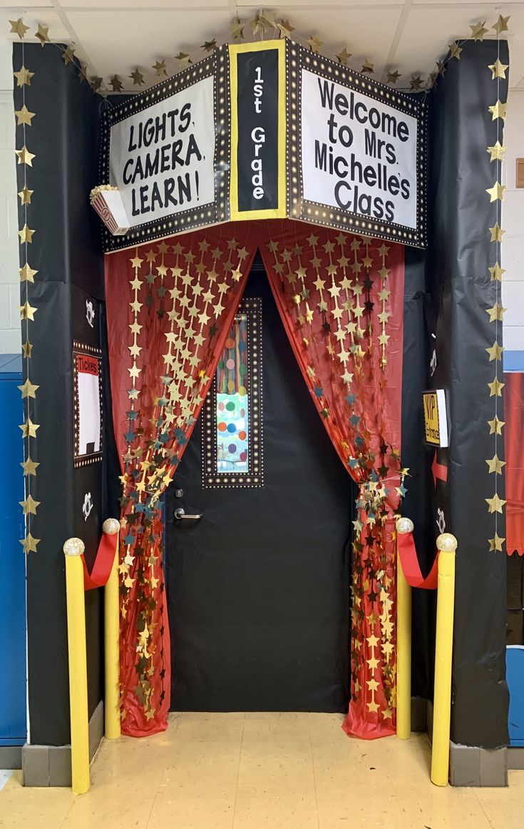 a door decorated with red curtains and yellow poles in front of a black backdrop that says welcome to the children's camera learn