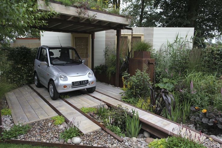 a small car parked in front of a house