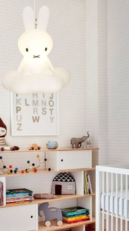 a baby's room with a white crib and toys